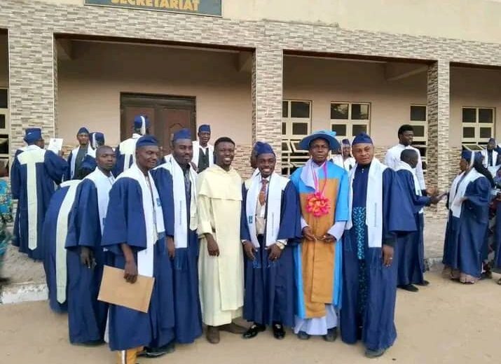 Graduates with a priest